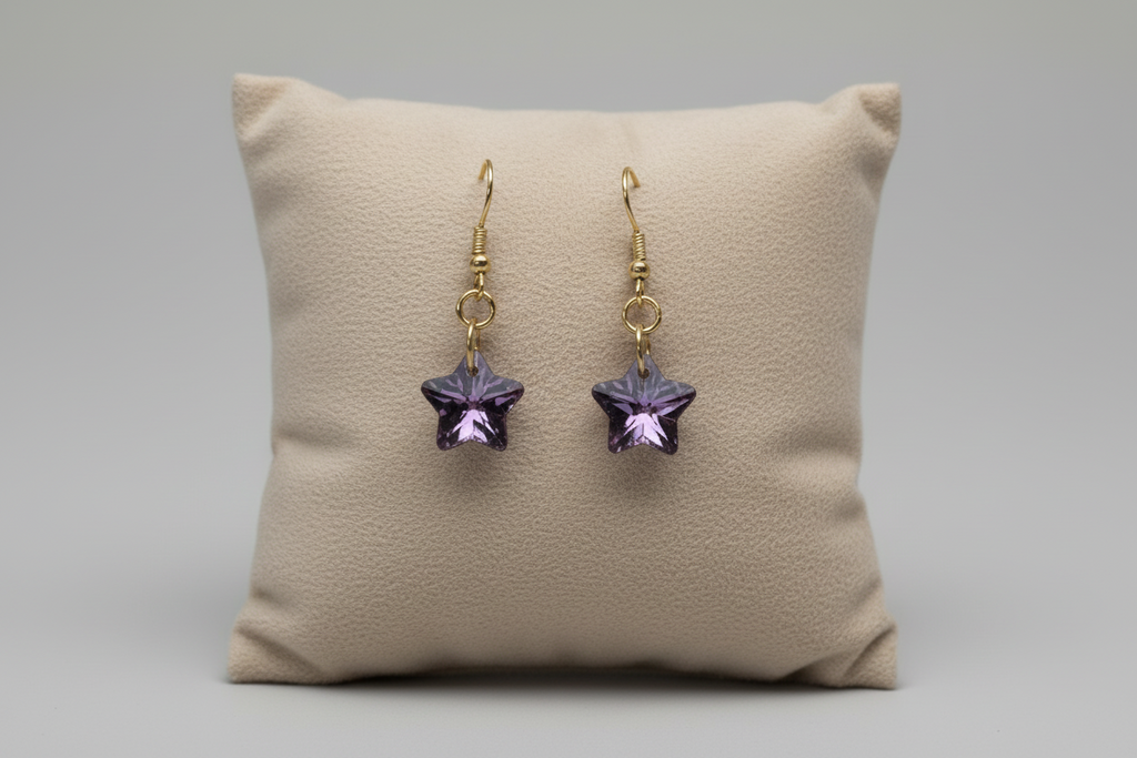 Sparkly star earrings on white background