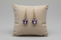 Sparkly star earrings on white background